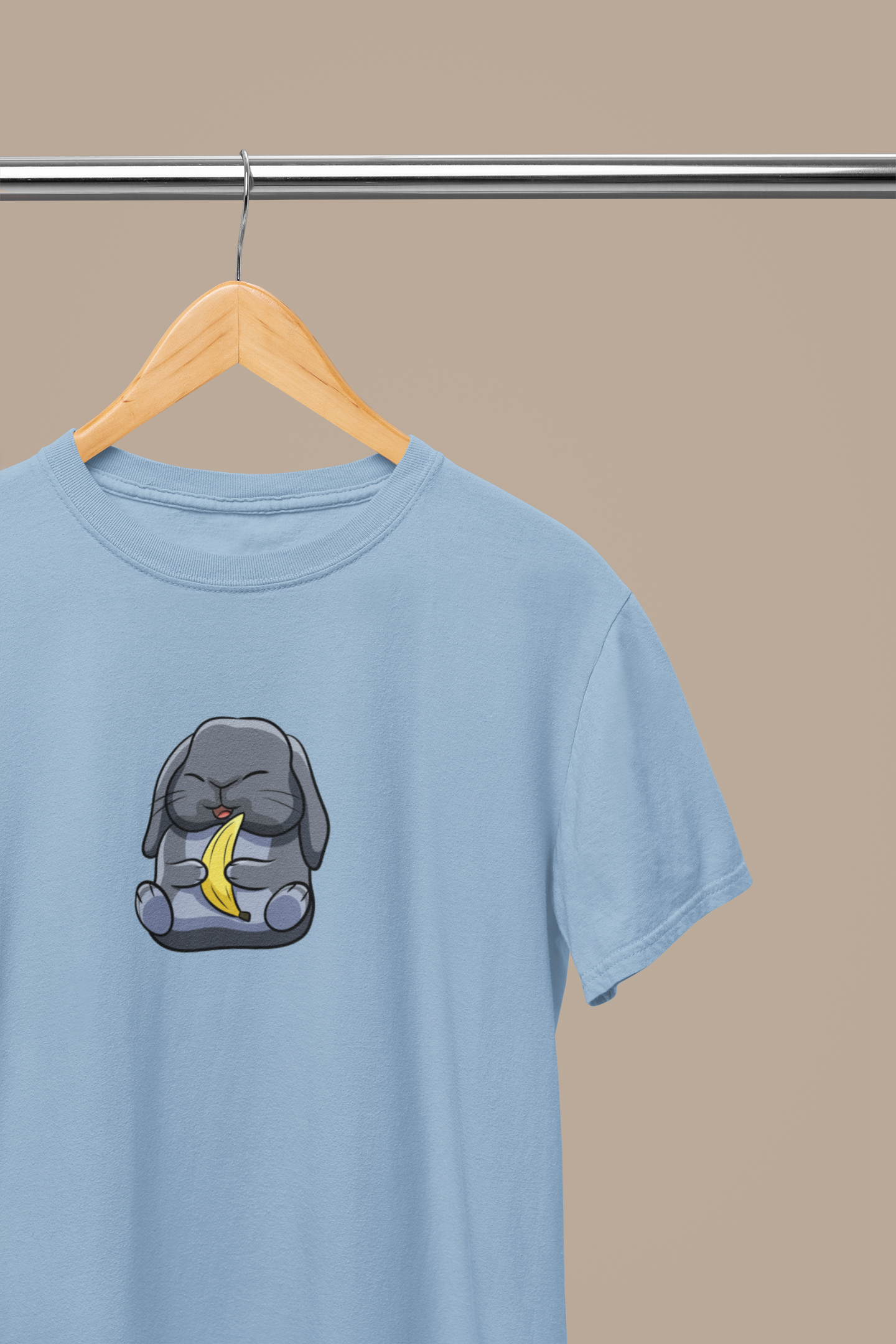 Heavyweight Unisex Crewneck T-shirt in light blue with a cute cartoon bunny holding a banana printed on the front of the t-shirt