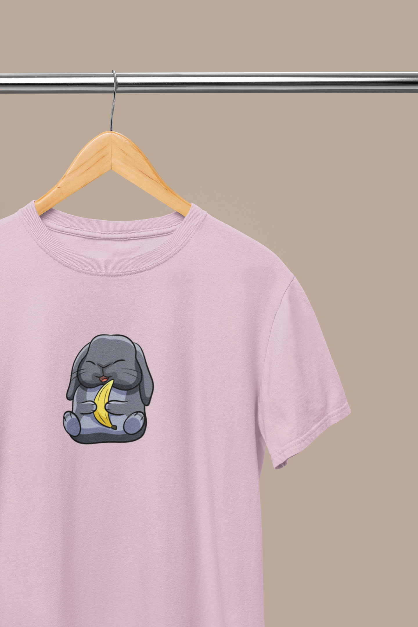 Heavyweight Unisex Crewneck T-shirt in light pink with a cute cartoon bunny holding a banana printed on the front of the t-shirt