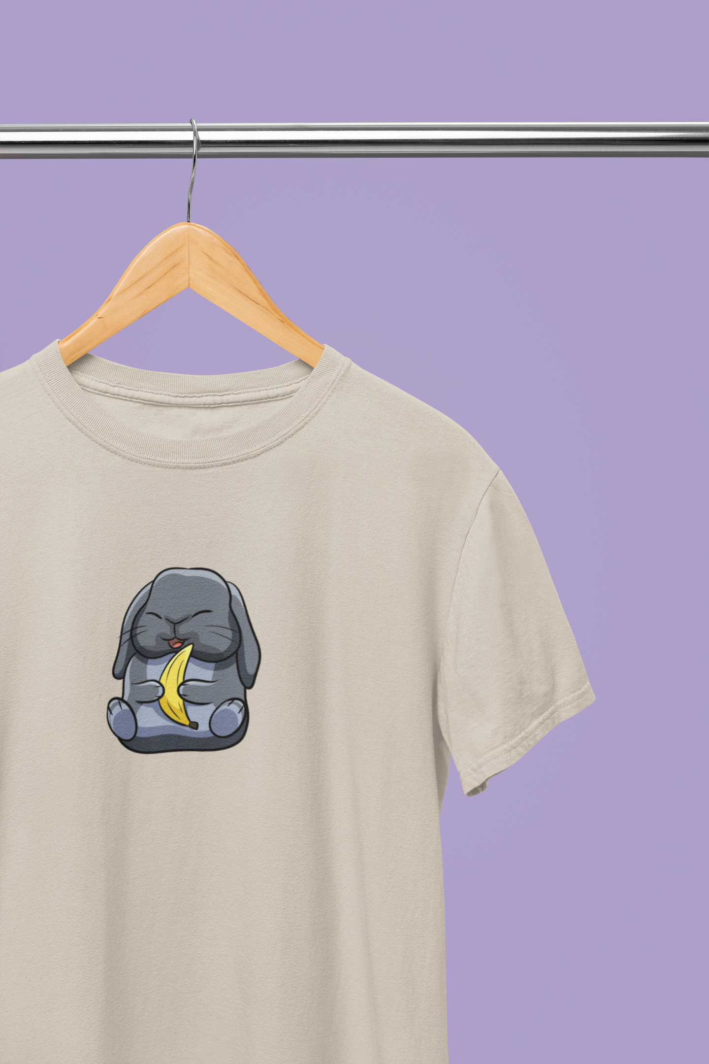 Heavyweight Unisex Crewneck T-shirt in sand with a cute cartoon bunny holding a banana printed on the front of the t-shirt